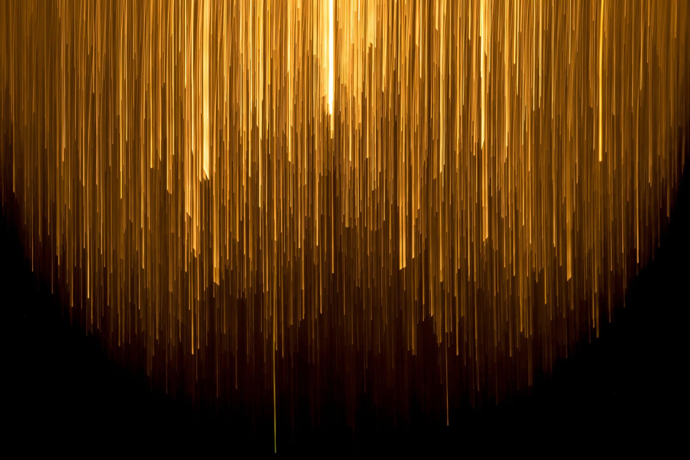 A very long line of yellow lines at different brightnesses on a black background