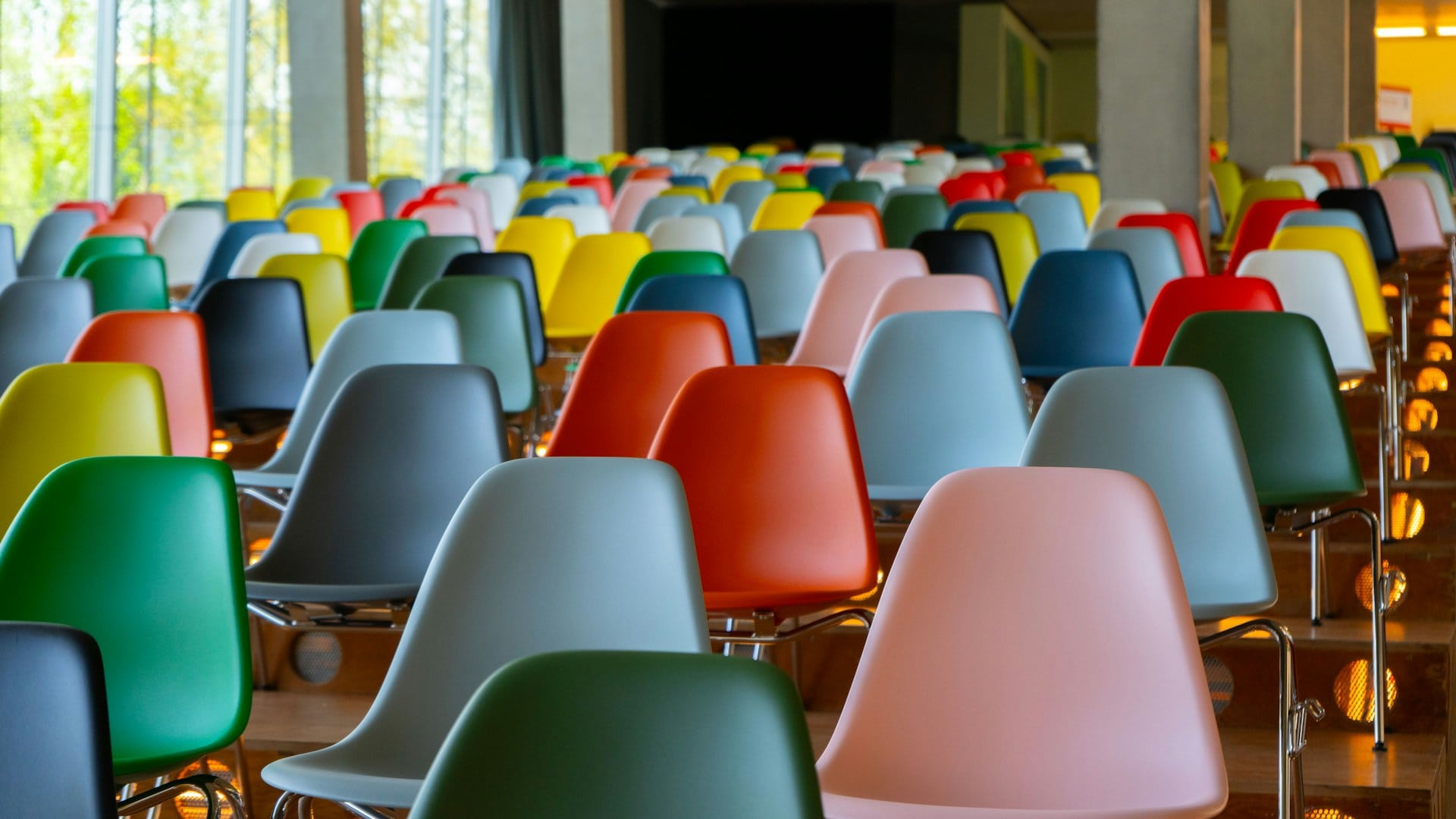 Auditorium seating full of colorful chairs