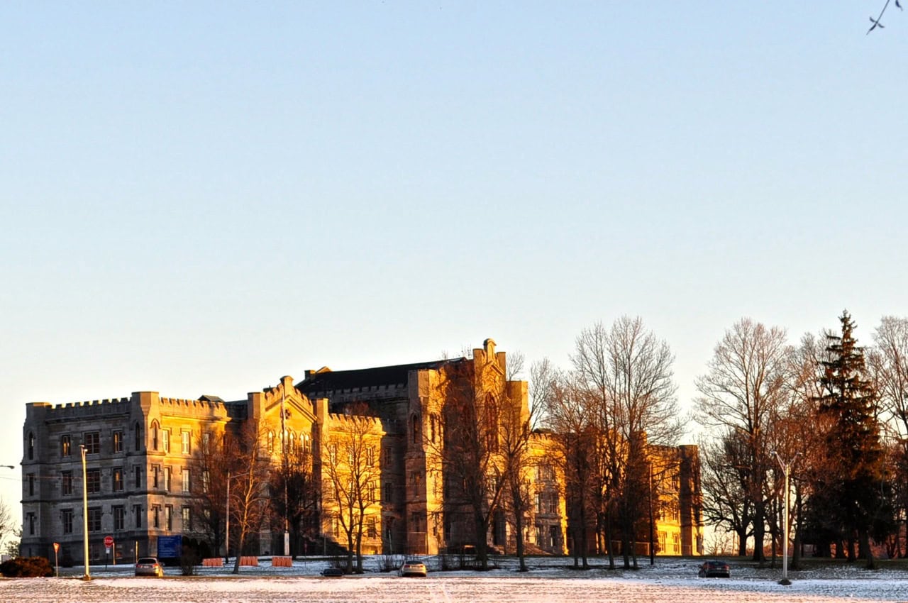 An old hospital with the sun shining brightly on the building