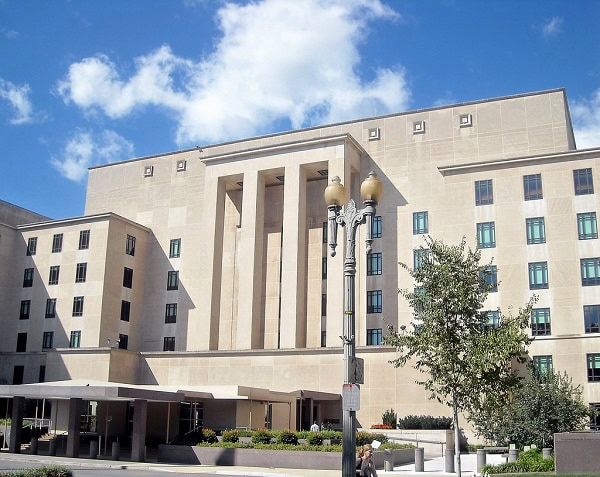 A large white building with a blue sky in the background